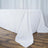 White tablecloth draped elegantly over a wooden table.