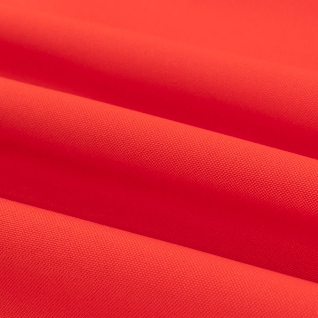 Red fabric texture with soft folds and smooth surface.