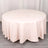 Round pink tablecloth draped elegantly over a table.