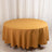 Round mustard yellow tablecloth draped over a table.