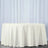 White tablecloth draped over a round table against a light backdrop.