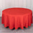 Round red tablecloth on a wooden table.