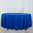 Round blue tablecloth draping over a table in a studio setting.
