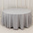 Round gray tablecloth draped over a circular table in a studio setting.