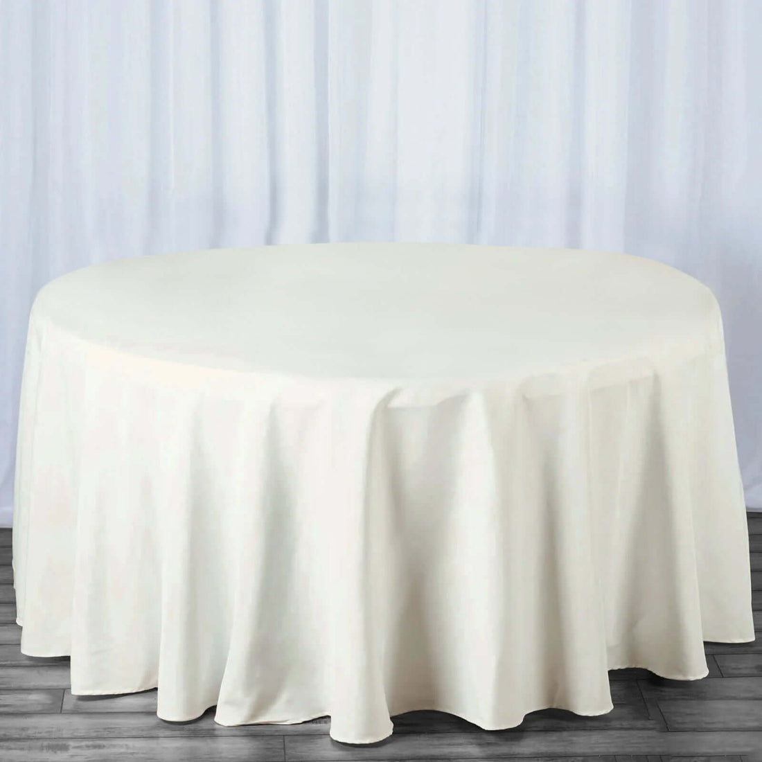 Round white tablecloth draped elegantly over a round table.