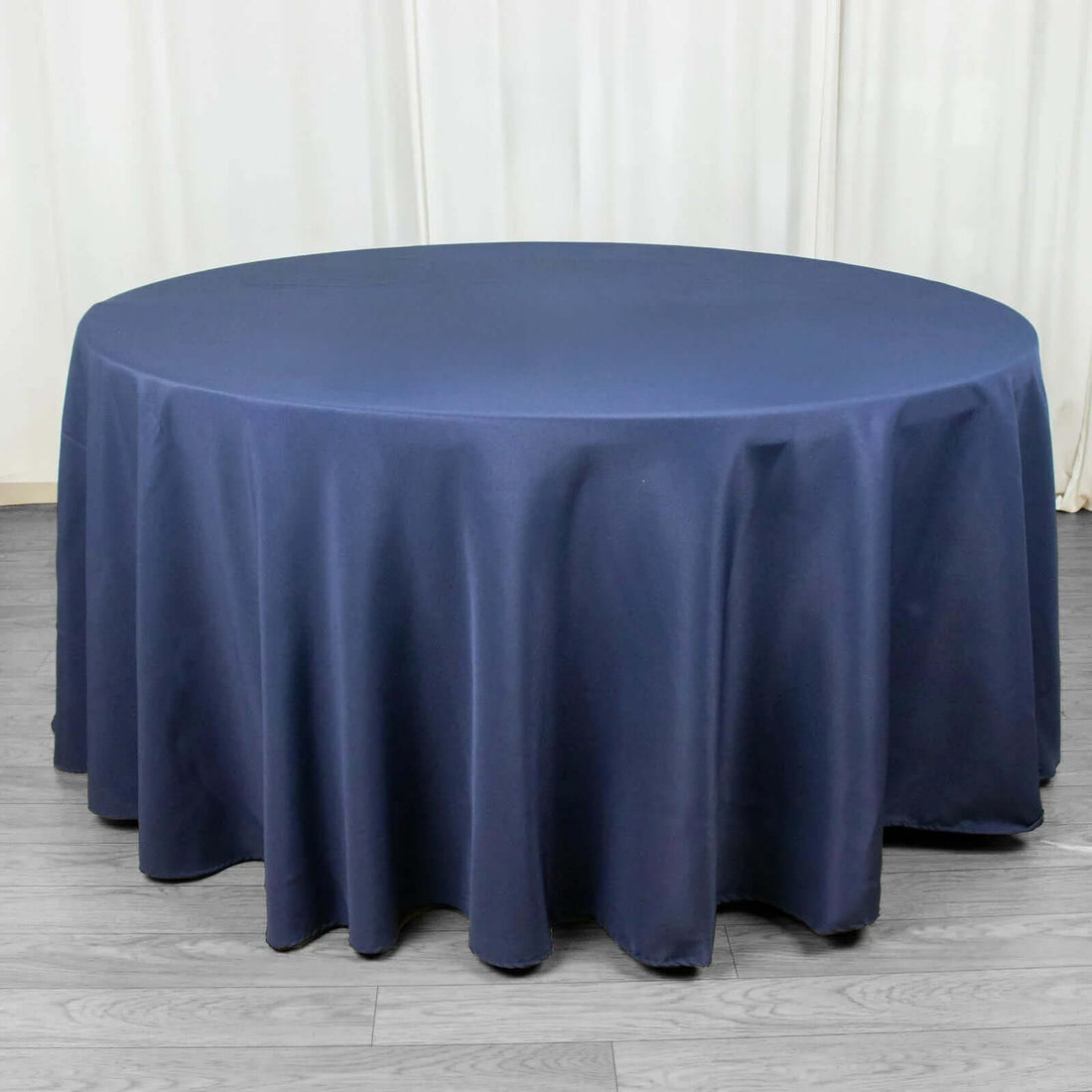 Round navy tablecloth draped elegantly on a table