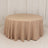 Round beige tablecloth with elegant draping on a plain backdrop.