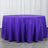 Purple round tablecloth draped over a table in studio setting.