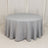 Round grey tablecloth draped elegantly over a circular table.