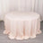 Round blush tablecloth elegantly draped on a table.