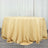 Round table covered with a beige tablecloth.