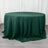 Green round tablecloth draped over a table on a wooden floor.