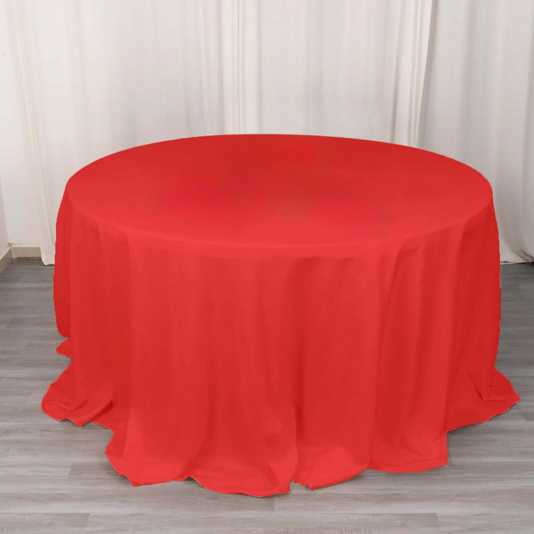 Red round tablecloth draped elegantly on a table.