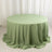 Round green tablecloth on a table with soft draping.