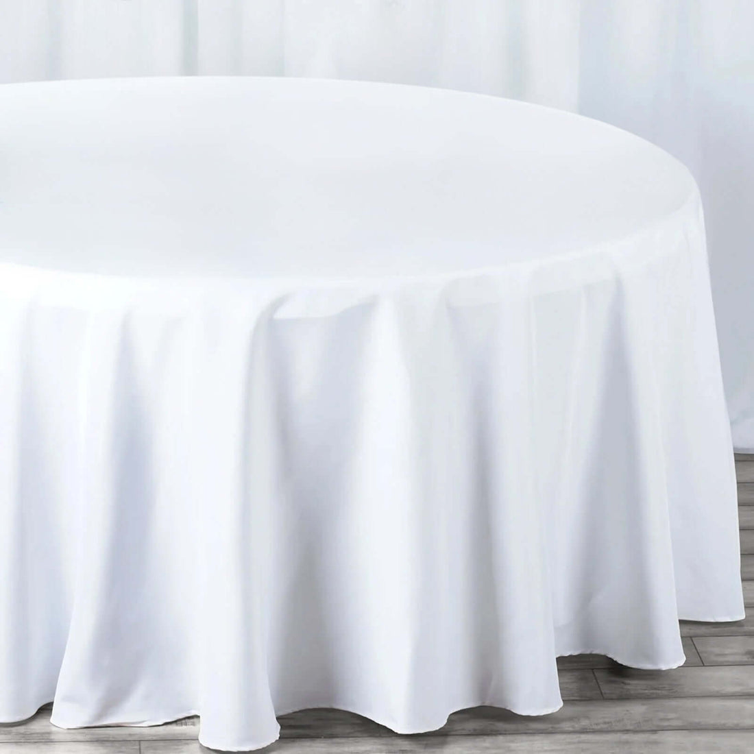 Round white tablecloth draped elegantly over a table