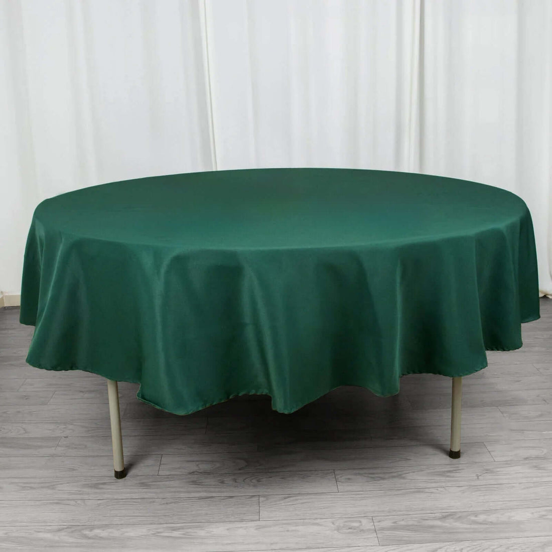 Round green tablecloth draped elegantly over a table.