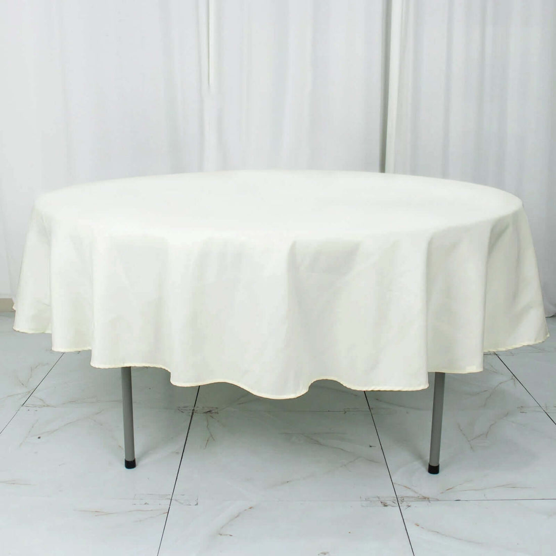 Round cream tablecloth on a round table