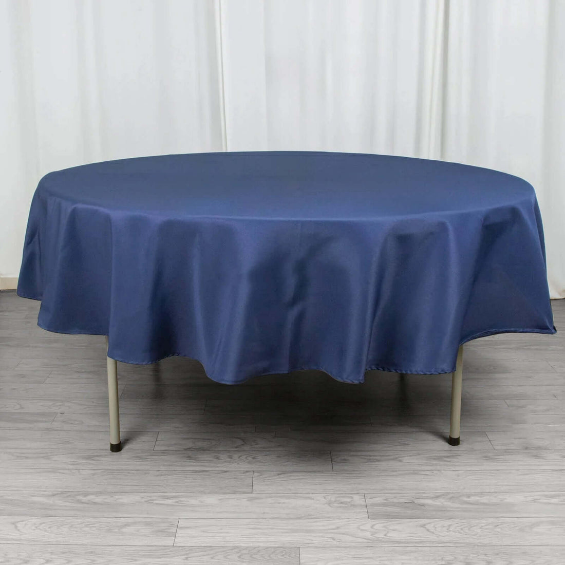 Round navy tablecloth draped over a table.