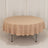 Round table with a beige tablecloth on a plain backdrop