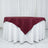 Burgundy tablecloth draped over a white table, styled for events or dining.