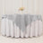 Gray table runner on a white tablecloth with floral centerpiece.