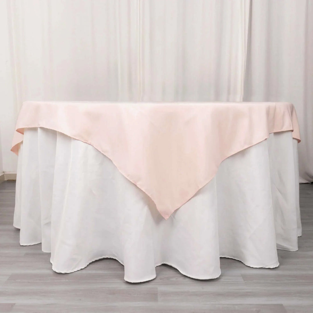 Pink tablecloth draped elegantly over a round table.