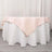 Pink tablecloth draped elegantly over a round table.