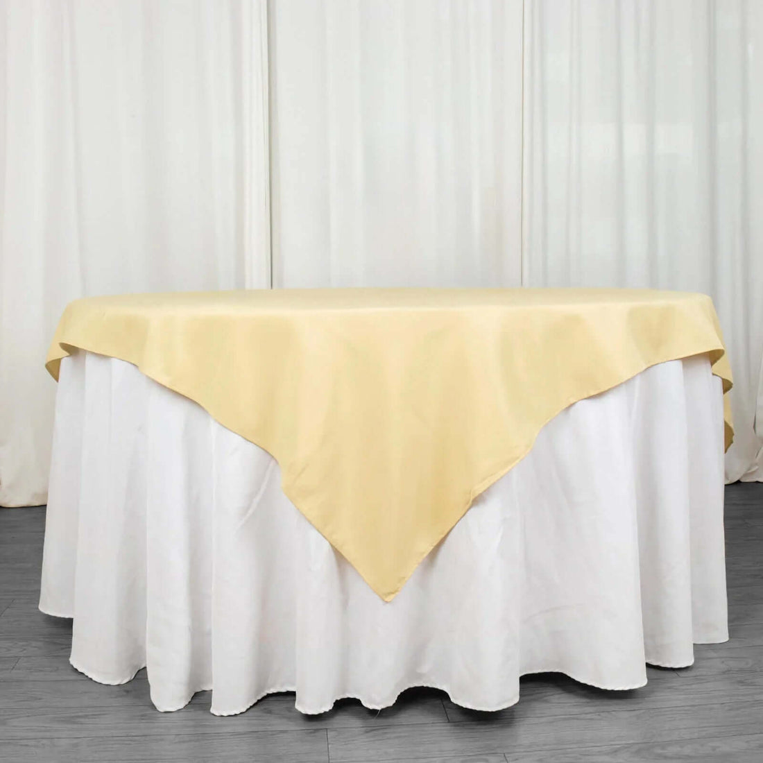 Yellow tablecloth draped elegantly over a round white table.