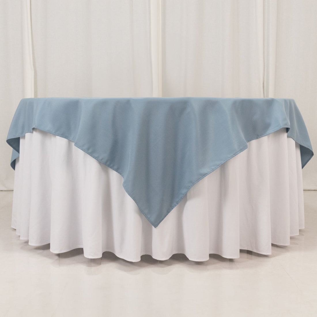 Round table with a blue and white tablecloth.