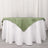 Green satin tablecloth draped over a white table.