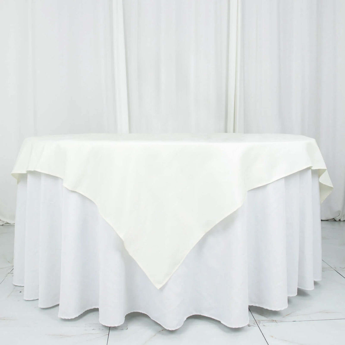 White tablecloth with elegant draping and scalloped edges