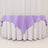 Purple tablecloth draped over a round table with a white skirt.