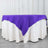 Purple tablecloth draped over a white table for elegant decor.
