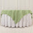 Green tablecloth draped over a white table for elegant dining decor.