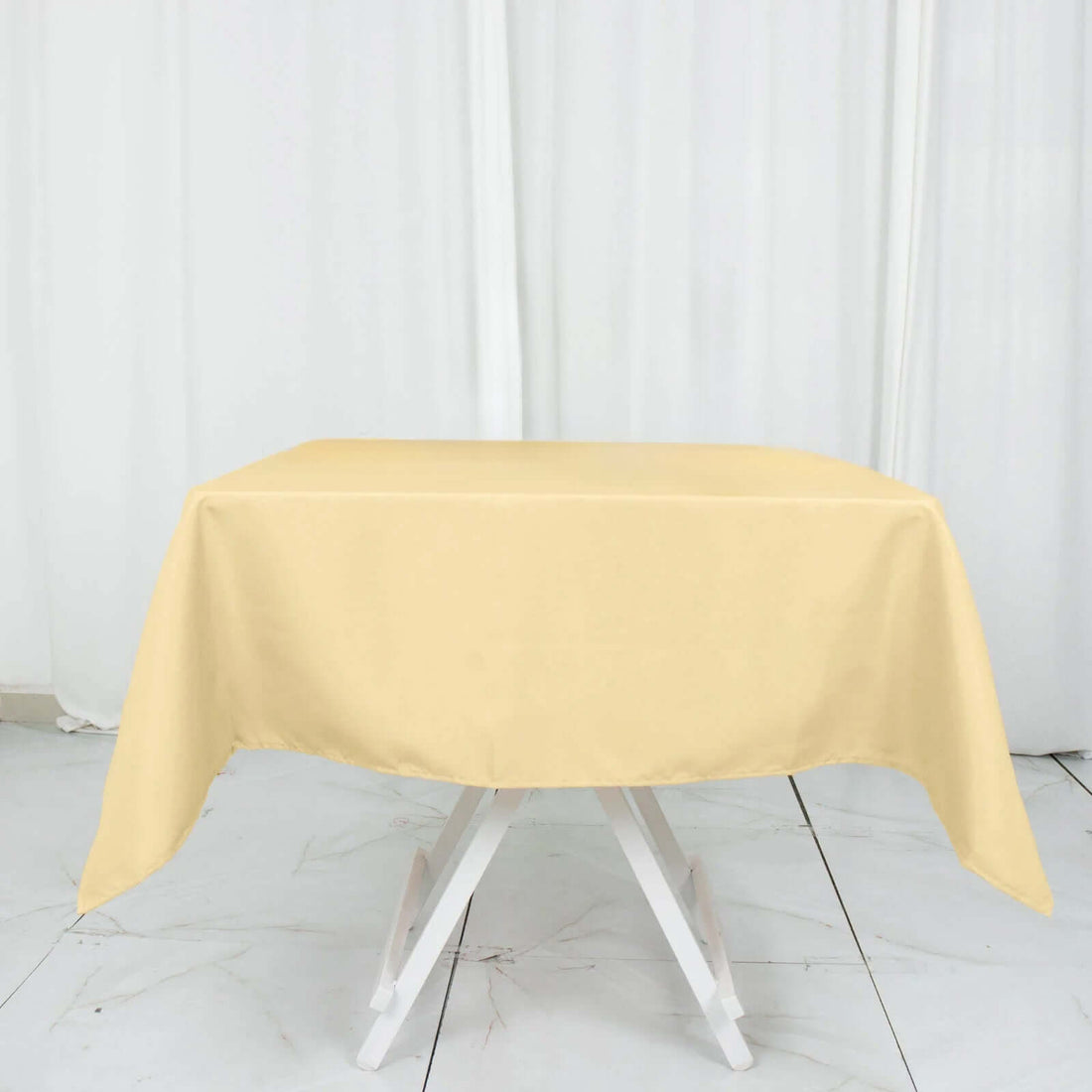 Yellow tablecloth draped over a white folding table