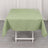 Green tablecloth draped over a table in a studio setting