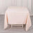 Peach tablecloth draped on a white table in a studio setting