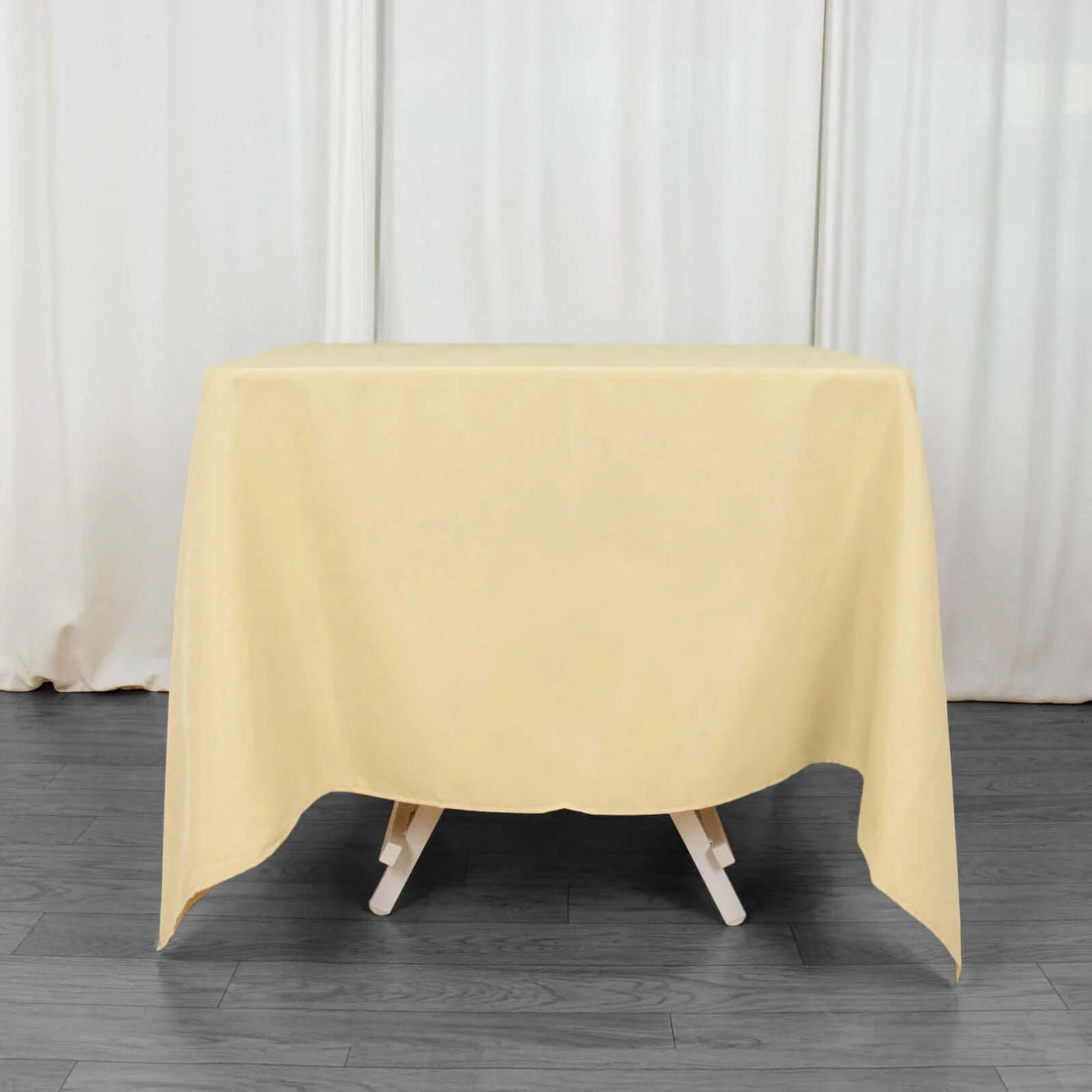 Yellow tablecloth draped over a table in a studio setting.
