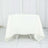 White tablecloth draped over a folding table in a studio setting