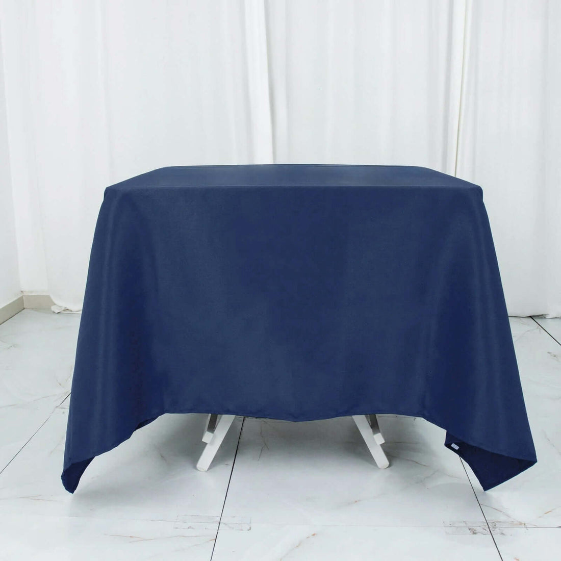Navy tablecloth draped over a table in a studio setting