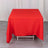 Red tablecloth draped over a table on a plain backdrop.