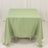 Green tablecloth draped over a square table, showcasing smooth fabric texture.