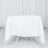 White table covered with a smooth tablecloth in a studio setting.