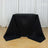 Black table cover draped over a table in a studio setting.