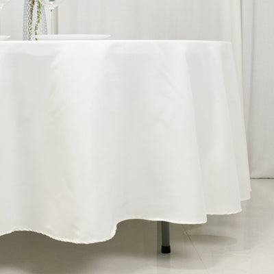 White tablecloth draped over a table in a minimalist setting.