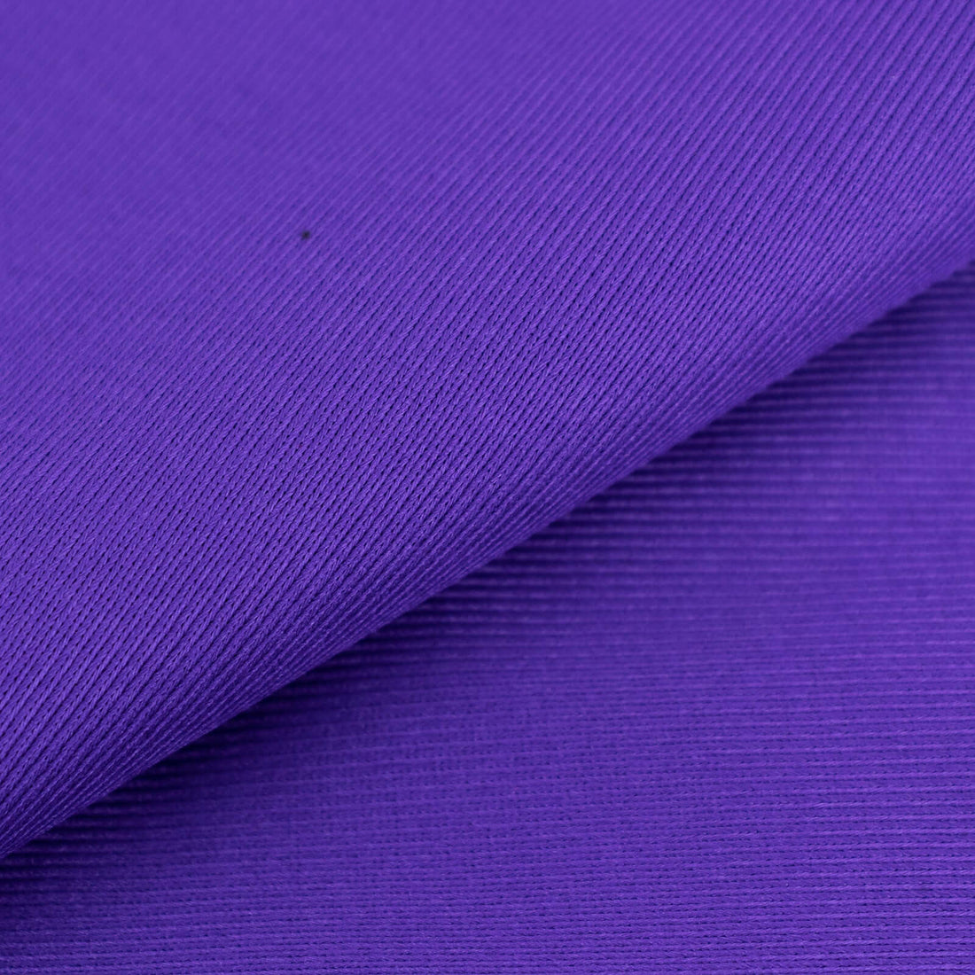 Purple textured fabric in a layered fold.