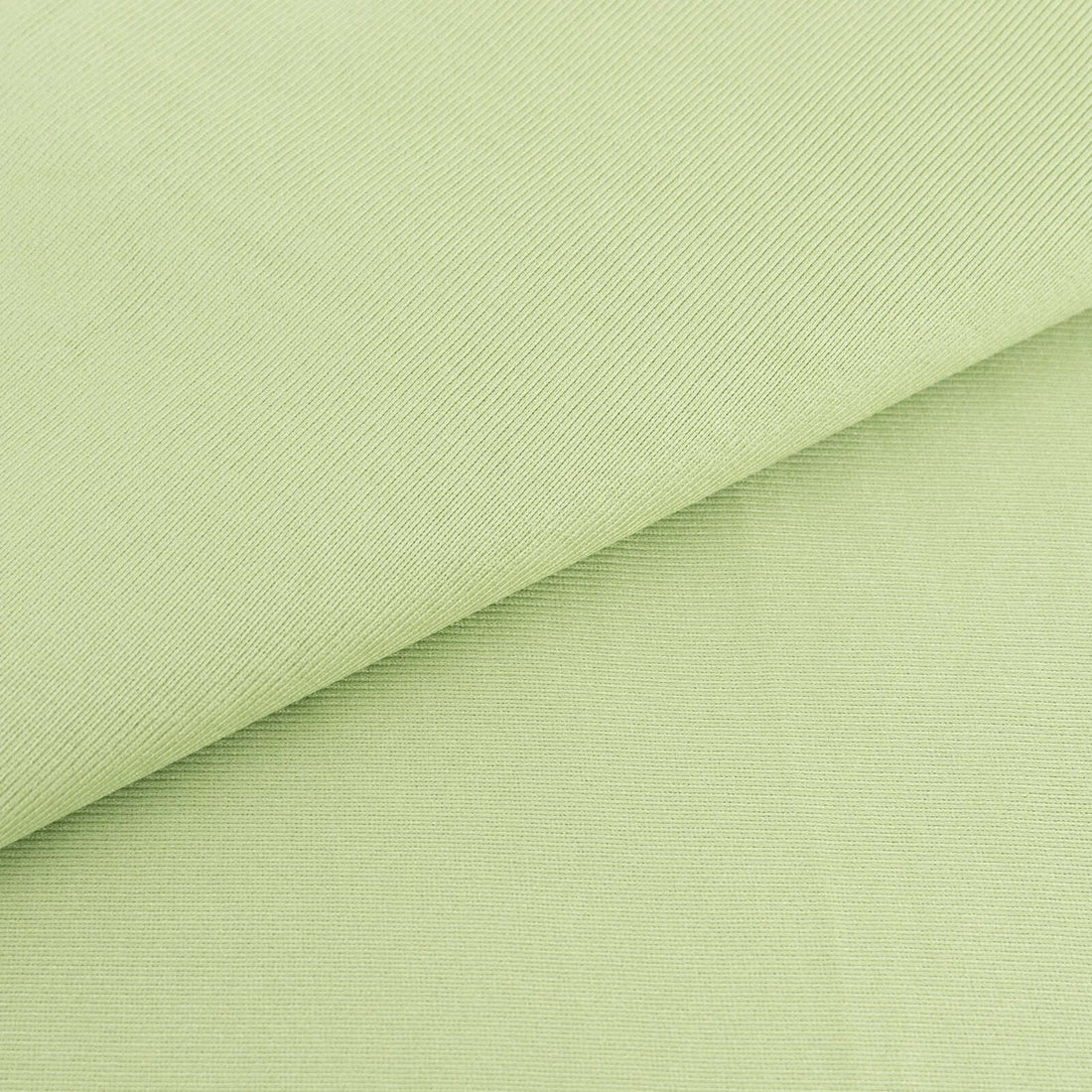 Light green textured fabric close-up for sewing and crafting projects.