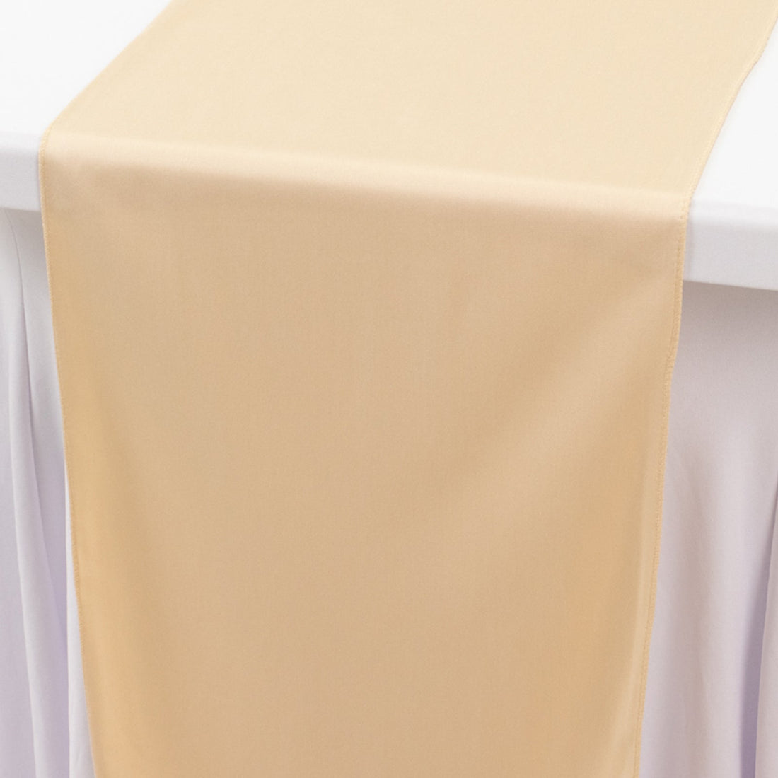 Beige table runner draped over a white table.