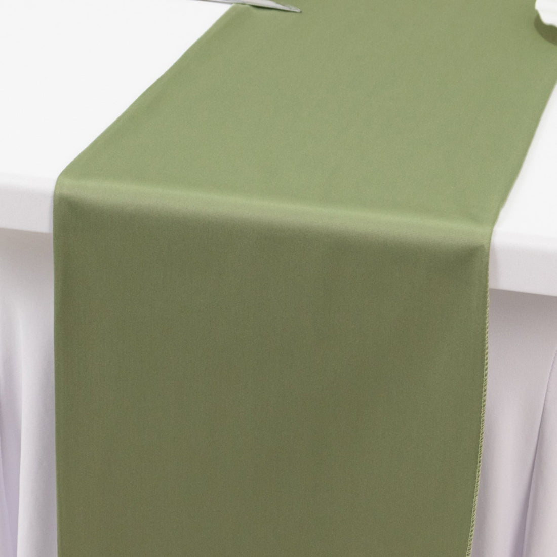 Olive green table runner on a white tablecloth