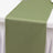 Olive green table runner on a white tablecloth